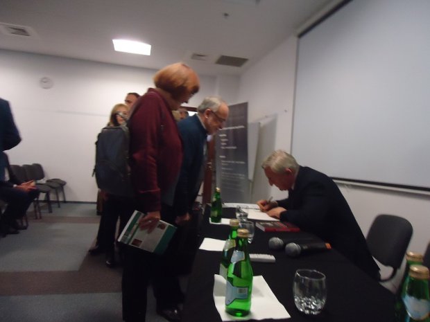 Prof. Szaflik podpisuje książkę - spotkanie promocyjne
