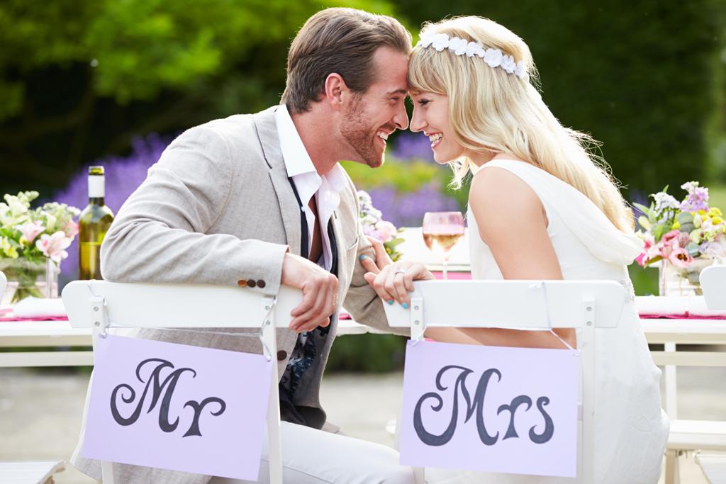 Bride And Groom Enjoying Meal At Wedding Reception