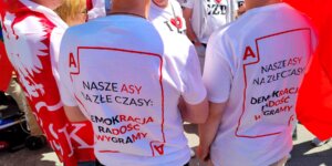 Marsz demokracji i wolności - koszulki z napisem "Nasze asy na złe czasy: Demokracja, Radość, Wygramy. W kolorach białoczerwonych